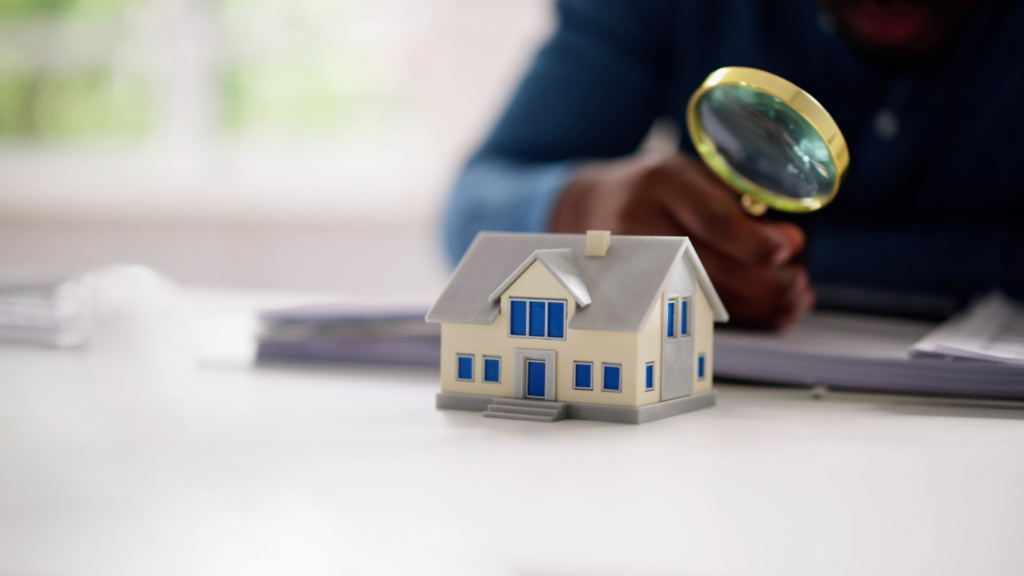 House model and magnifying glass 