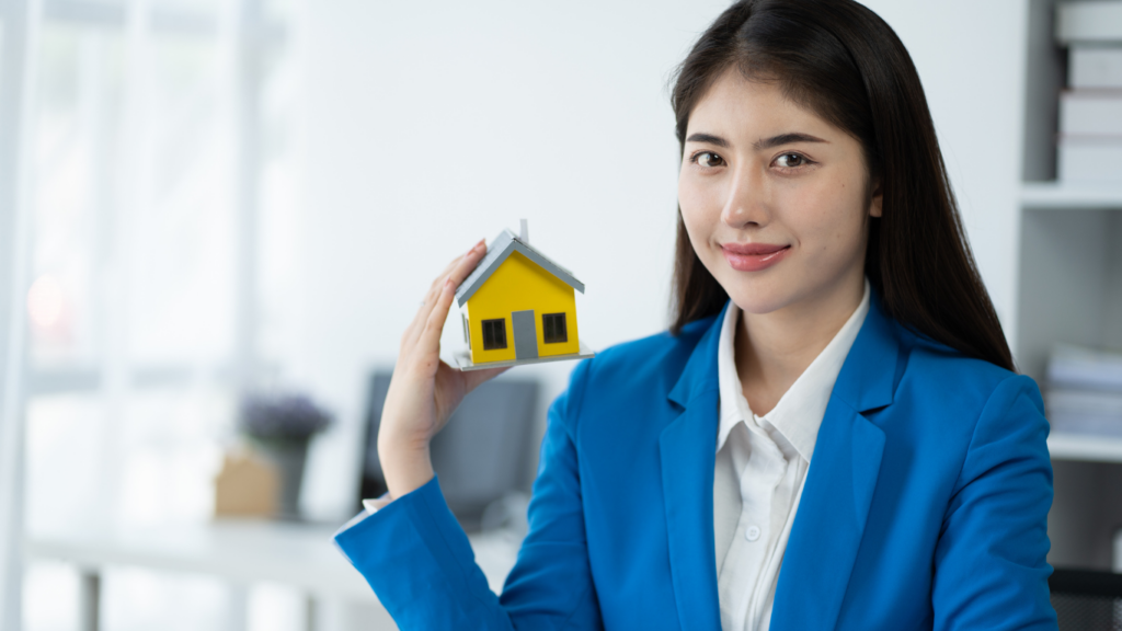 Lady holding a house model