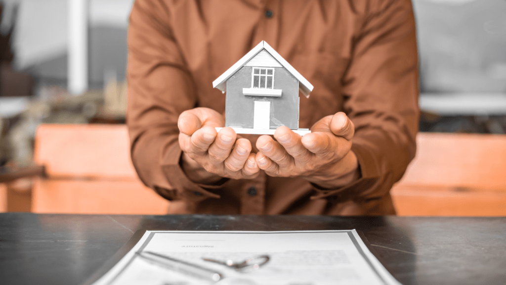 Sales Agent holding a House Model